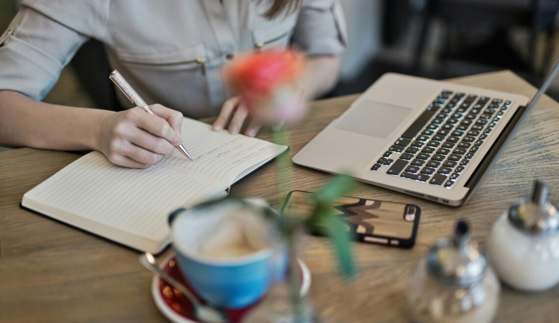person writing in a journal