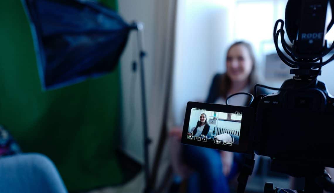 View behind a camera of an interview