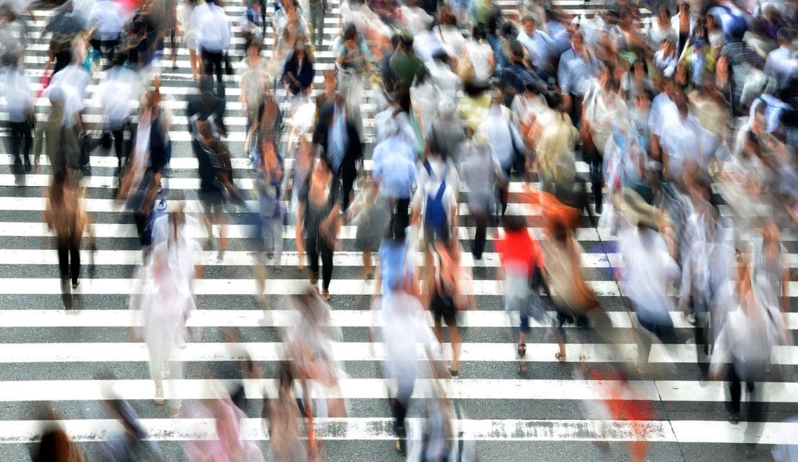 Blurred crowd of people in a crosswalk