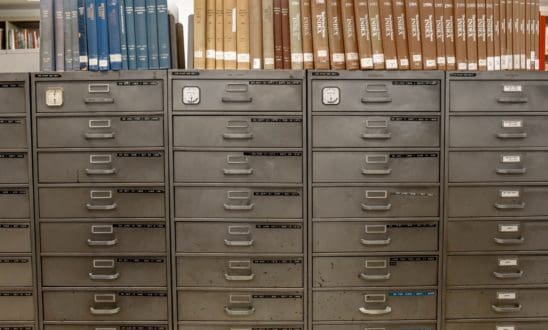 Filing cabinet system with books color organized on top
