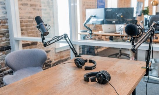 Desk with podcasting equipment (microphone, headphones)