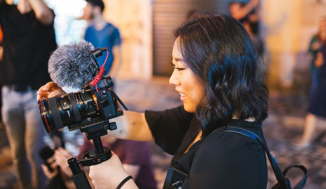 Woman holding camera with microphone