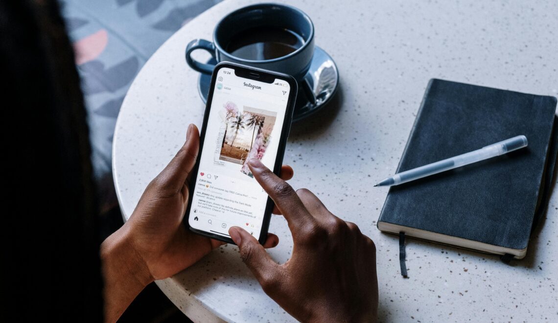 person scrolling on Instagram on a phone