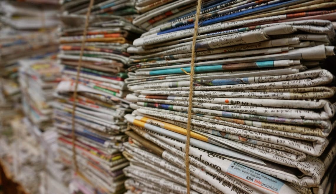 Endless stacks of folded newspapers bound in twine