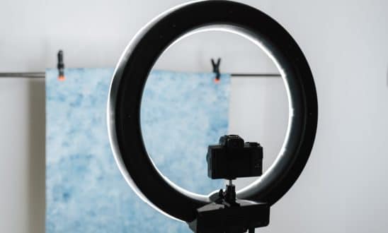Ring light and camera with a colored background in the background