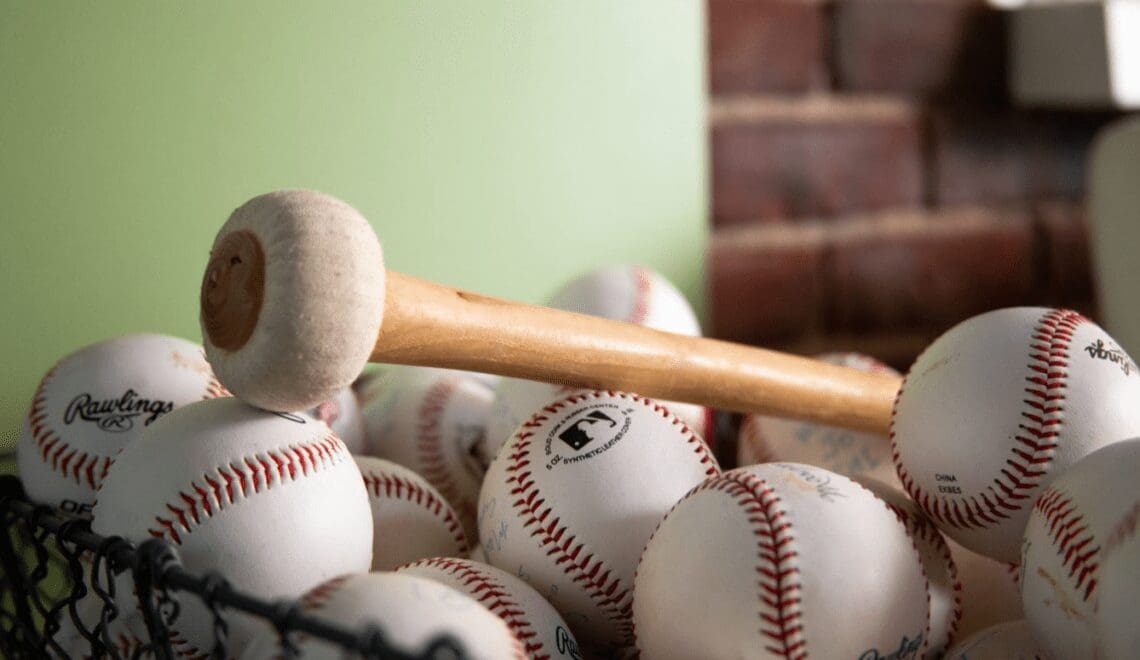 Basket of baseballs with Gong mallet laying on top