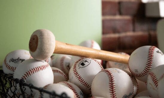 Basket of baseballs with Gong mallet laying on top