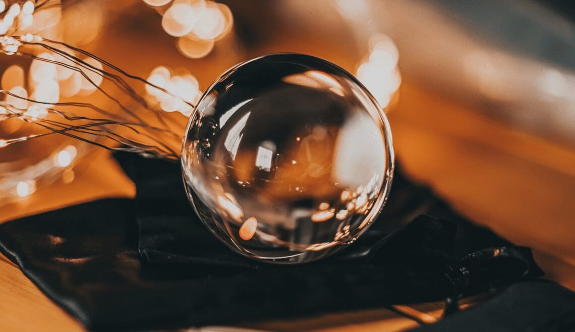 Glass crystal ball with soft lighting in the background