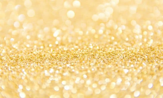 Extreme close-up of a pile of gold, shiny glitter