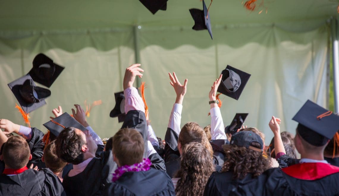 Graduates throwing up caps at commencement