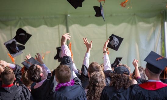 Graduates throwing up caps at commencement